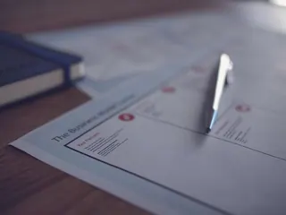 A pen resting on a business document